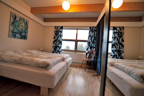 a bedroom with two beds and a window at Reykjavik Peace Center Guesthouse in Reykjavík