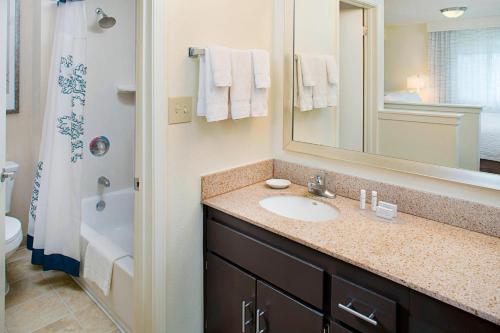 a bathroom with a sink and a mirror at Residence Inn Sacramento Cal Expo in Sacramento