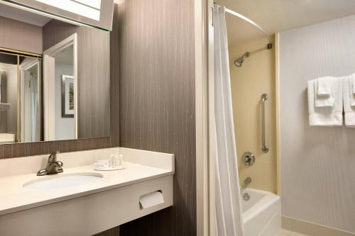 a bathroom with a sink and a shower at Courtyard by Marriott Tysons McLean in Tysons Corner