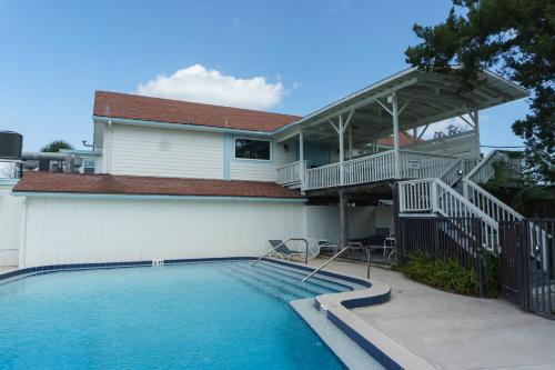 a house with a swimming pool in front of a house at Inn at Camachee Harbor View 11 in Saint Augustine