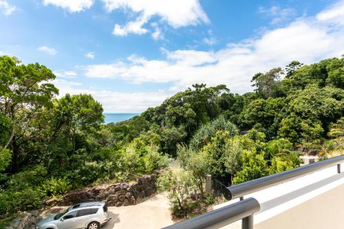 a car parked on a balcony with the ocean in the background at Papillon Coolum in Coolum Beach