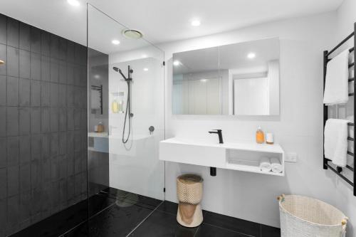 a bathroom with a sink and a shower at Papillon Coolum in Coolum Beach