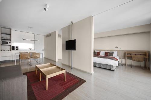 a bedroom with a bed and a living room at Design Apart in Buenos Aires