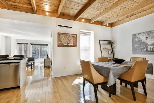 a kitchen and dining room with a table and chairs at STUNNING condos on ST Denis in Montréal