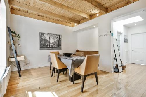 a dining room with a table and chairs at STUNNING full APARTMENTS - stocked KITCHENS - WASHER & DRYERS - WORKSPACE PROVIDED - FAST WIFI - LOCATED on the FAMOUS ST Denis street - Near METRO MONT ROYAL in Montreal