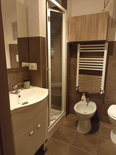 a bathroom with a toilet and a sink and a shower at La Casina b&b in Ancona
