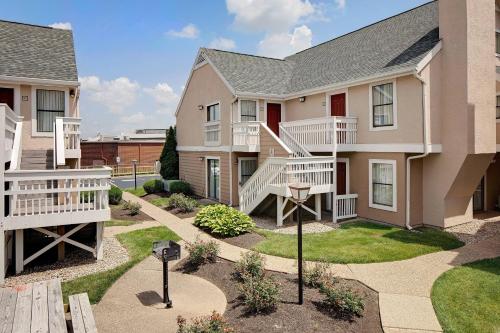 a apartment building with stairs and a yard at Residence Inn Louisville East in Louisville