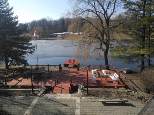 a large wooden dock with chairs and a lake at Lakeside Private suite-Queen bed room in Tottenham