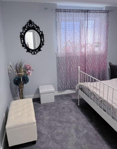 a bedroom with a bed and a mirror and a window at Banff Garden Suite&2mins Bus station Close LRT& Free Parking in Calgary