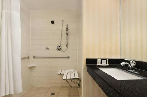 a bathroom with a sink and a shower at Fairfield Inn & Suites by Marriott Tupelo in Tupelo