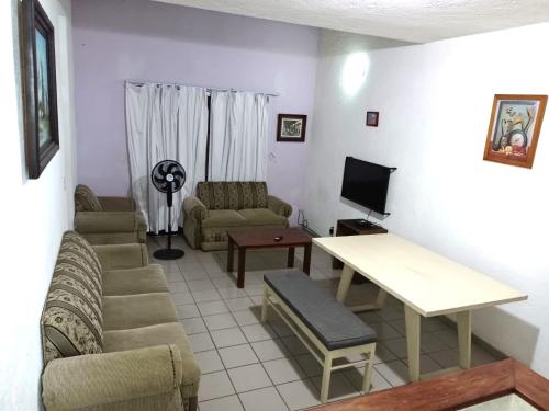 a living room with a couch and a table at Bonita casa amueblada para 12 personas a 3 Kms del centro Cuernavaca in Cuernavaca