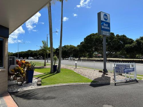 a gas station sign in front of a building at Best Western Ambassador Motor Lodge in Hervey Bay