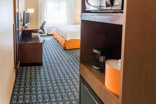 a hotel room with a bedroom with a bed at Fairfield Inn & Suites Sioux Falls in Sioux Falls