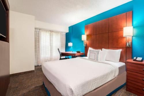 a hotel room with a large bed and a desk at Residence Inn Macon in Macon