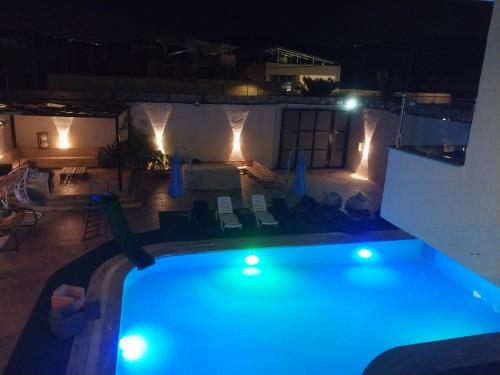 a swimming pool at night with blue lights at Tala Villa in Amman