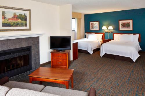 a hotel room with two beds and a fireplace at Residence Inn Minneapolis Eden Prairie in Eden Prairie