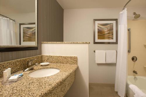 a bathroom with a sink and a shower at Courtyard by Marriott Hanover Lebanon in Lebanon