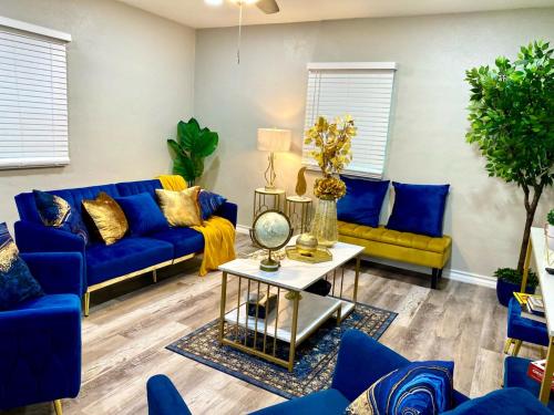 a living room with blue couches and a table at NEW! close to Downtown, Malls & Premium Outlets, with Balcony in Weslaco