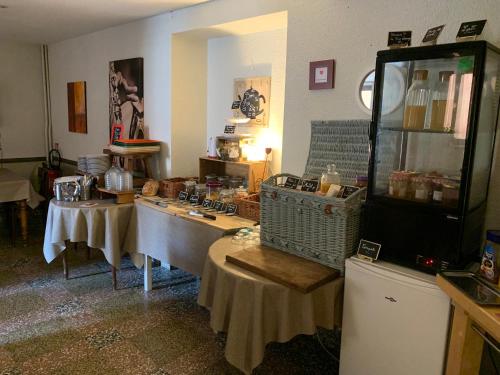 a room with two tables in a room with a room at Initial by balladins, Hôtel Restaurant Broisin in Aix-les-Bains