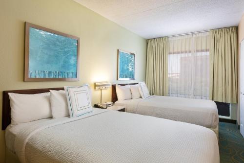 a hotel room with two beds and a window at SpringHill Suites Austin South in Austin