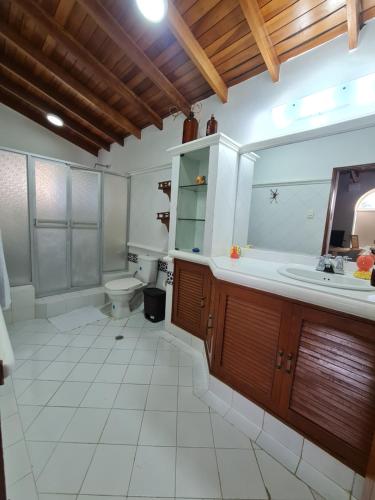 a bathroom with a tub and a toilet and a sink at Casa Blanca del Mar in Santa Marta