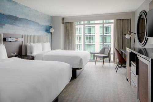 a hotel room with two beds and a television at Seattle Marriott Waterfront in Seattle