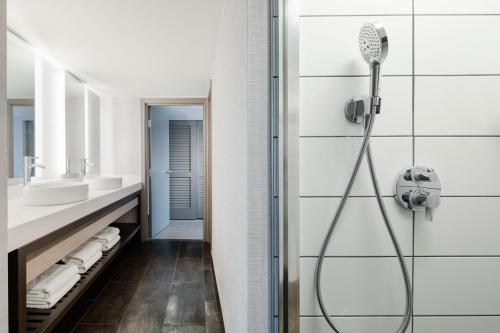 a bathroom with two sinks and a shower at Seattle Marriott Waterfront in Seattle