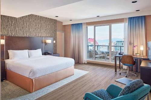 a hotel room with a bed and a desk at Residence Inn by Marriott Vancouver Downtown in Vancouver