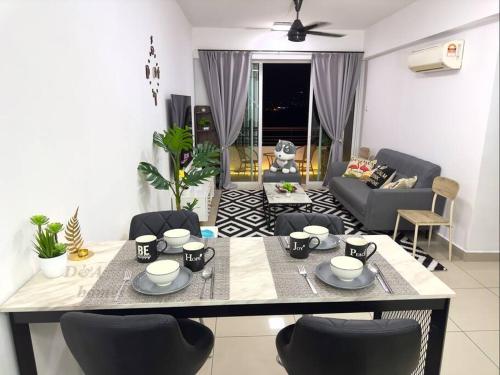 a kitchen and living room with a table and chairs at Ipoh Majestic Condo by D&A homes in Ipoh