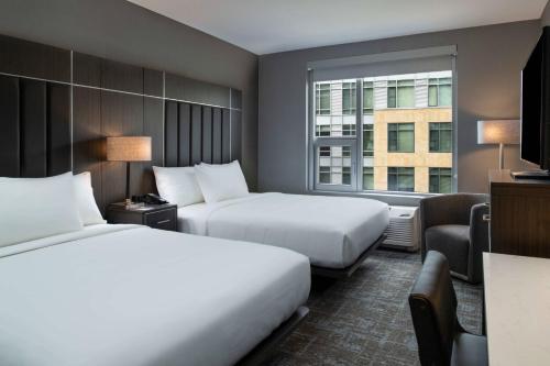 una camera d'albergo con due letti e una finestra di Fairfield by Marriott Inn & Suites Boston Medford a Medford