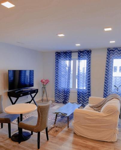 a living room with a couch and a piano at Banff Garden Suite&2mins Bus station Close LRT& Free Parking in Calgary
