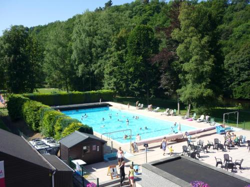 an overhead view of a swimming pool with people in it at Floreal La Roche-en-Ardenne in La Roche-en-Ardenne