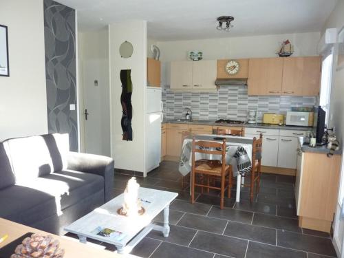Il dispose d'une cuisine et d'un salon avec un canapé et une table. dans l'établissement Appartement rénové, 6 pers, terrasse, parking, proche centre et plage - Cap d'Agde - FR-1-723-8, au Cap d'Agde