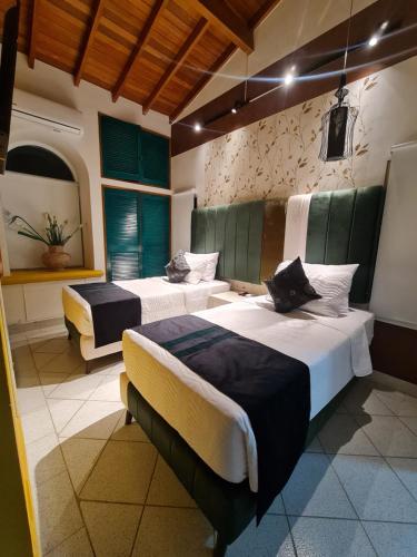 a bedroom with two beds in a room at Casa Blanca del Mar in Santa Marta