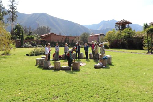 a group of people standing around in a yard at Hotel Villa Urubamba in Urubamba