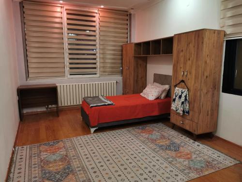 a bedroom with a red bed and a large window at Transit 77 in Istanbul