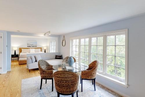 a living room with a couch and a table and chairs at Barn at the Beach - Main House in Georgetown
