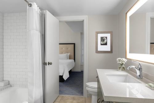 a bathroom with a sink and a toilet and a bed at Marriott's Harbour Club in Hilton Head Island