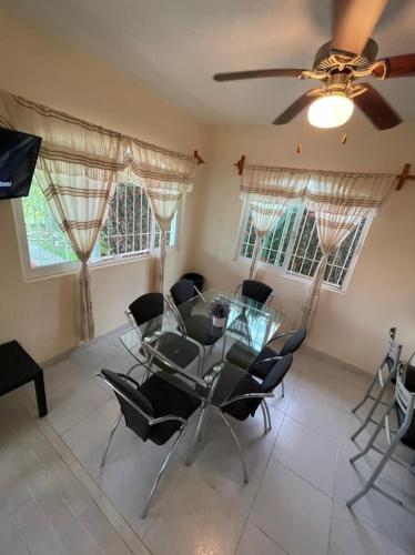 a dining room with a glass table and chairs at Casa Margarita 3BR Private Home with Balcony in Pérula