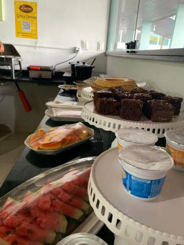 a buffet line with different types of food on plates at Hotel de Trânsito da PM-PE in Olinda