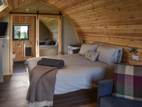 a bedroom with a large bed in a cabin at Wheal Breage - Uk41265 in Germoe