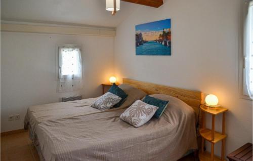 a bedroom with a bed with two pillows on it at Amazing Home In Portiragnes With Outdoor Swimming Pool in Portiragnes