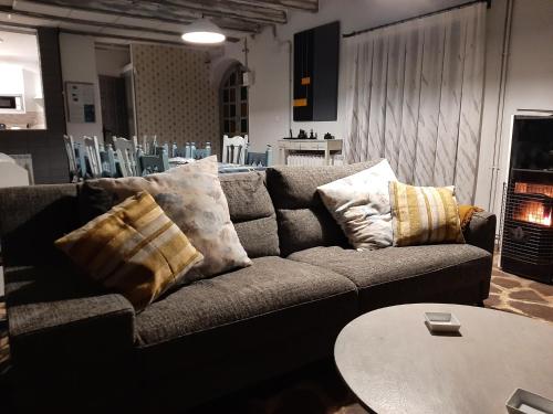 a couch in a living room with pillows on it at Casa rural "Garnacha de Borja" guest home in Borja