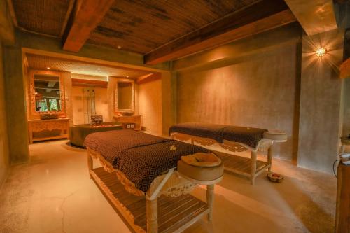 a bedroom with two beds in a room at Kastara Resort in Ubud