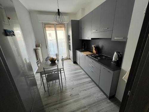 a kitchen with a table and a dining room at Casa di Afi, Perfect For 4 - Kitchen - Parking - Netflix in Arona