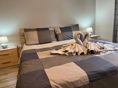 a bed with a blanket and two swans on it at Casa di Afi, Perfect For 4 - Kitchen - Parking - Netflix in Arona
