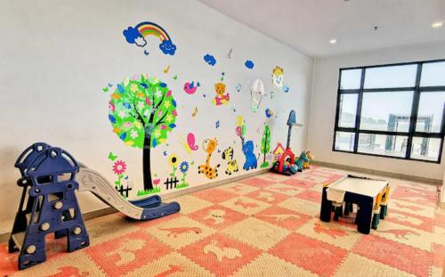 a childs room with a mural of a tree at Leisure Imperium Residence Studio Seaview Kuantan in Kuantan