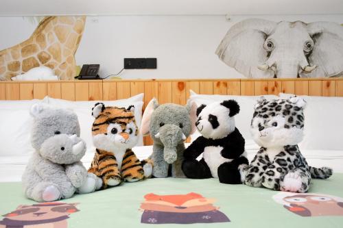 a group of stuffed animals sitting on a bed at The Granite Luxury Hotel Penang in George Town