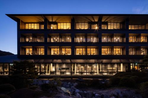 a large building with many windows at night at Unzen Miyazaki Ryokan in Unzen