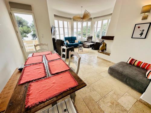 a living room with a table and a couch at Centre San Peire Les Issambres in Les Issambres